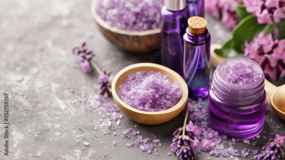 Spa concept with purple bath salts, essential oils, and fresh lilac flowers Spa concept with purple bath salts, essential oils, and fresh lilac flowers