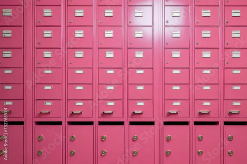 Pink steel Mailboxes in an apartment residential building inside. Modern rows of numbered mailbox, creative design mail backgrounds. Urban correspondence concept. Copy ad text space. Generated Ai