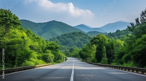 Asphalt road and green forest with mountain nature landscape in Hangzhou  China.