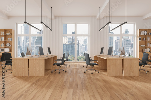 Stylish coworking interior with desk and shelf, workplace near panoramic window © ImageFlow