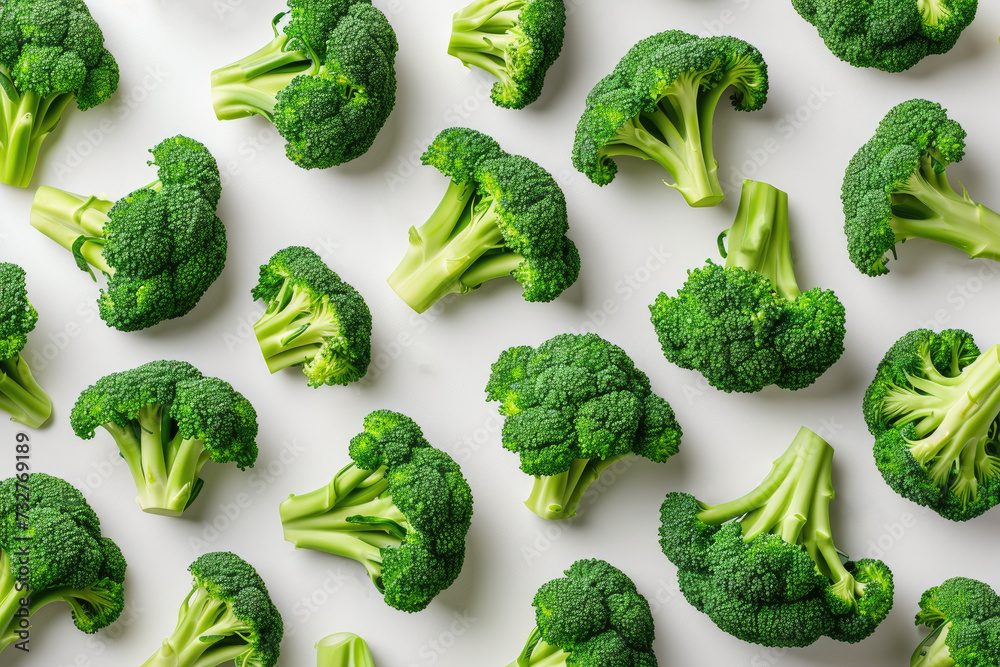 A Pile of Broccoli Florets on a White Surface Fresh broccoli florets arranged neatly on a clean white surface. A Pile of Broccoli Florets on a White Surface Fresh broccoli florets arranged neatly on a clean white surface.