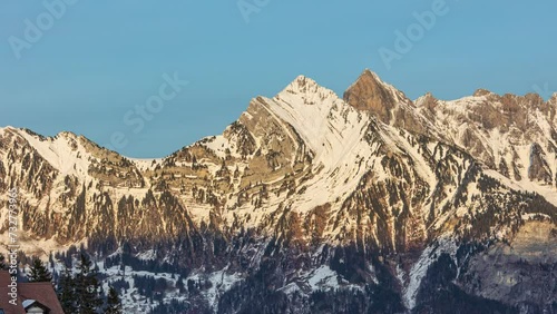 Time lapse, sunset over snowy mountains. Hinderrugg mountain peak, Churfirsten group, Appenzell Alps. Canton St. Gallen, Switzerland. photo