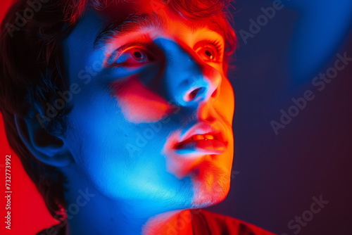Bipolar disorder is depicted in this portrait through the interplay of red and blue lights, symbolizing the emotional highs and lows experienced by individuals with the condition.