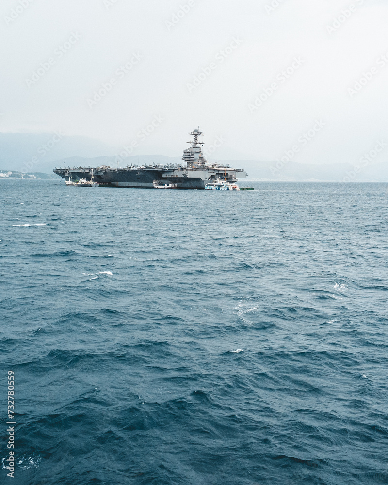 Massive vessel sails alongside another ship in the vast ocean Massive vessel sails alongside another ship in the vast ocean