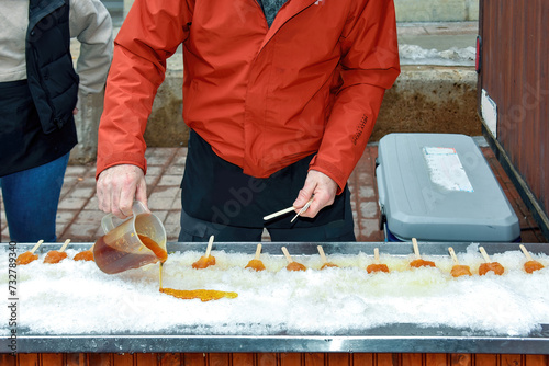 Man creates Maple taffy in the snow.