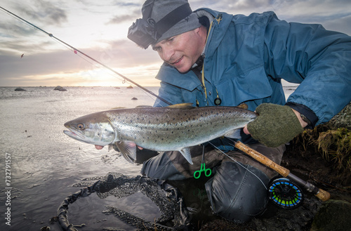 Winter sea trout fishing at the sunrise photo