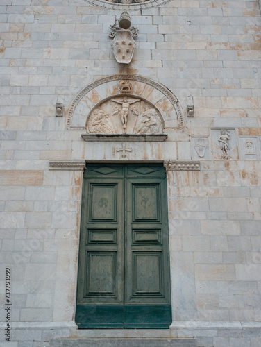 Door of a church surmounted by a lunette depicting the Crucifixion