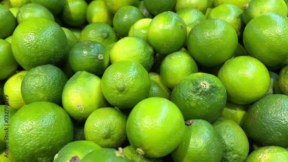 Extreme close-up of colorful fruit and vegetable stand with mangoes, limes, and tomatoes. Juicy-looking yellow, green, and red fruit for sale on stall. Natural healthy food. High quality 4k footage Extreme close-up of colorful fruit and vegetable stand with mangoes, limes, and tomatoes. Juicy-looking yellow, green, and red fruit for sale on stall. Natural healthy food. High quality 4k footage
