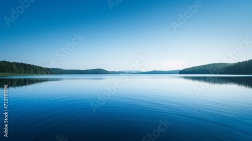 A tranquil lake reflecting the clear blue sky, creating a sense of serenity a...