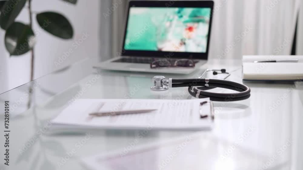Stethoscope and medication history record form are lying on the glass table. Medicine and healthcare. Doctor workplace Stethoscope and medication history record form are lying on the glass table. Medicine and healthcare. Doctor workplace
