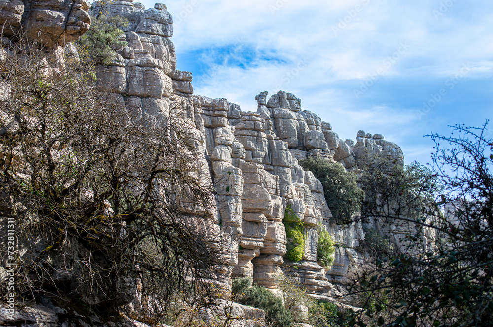 Hiking the Torcal de Antequerra National Park, limestone rock formations and known for unusual karst landforms in Andalusia, Malaga, Spain.