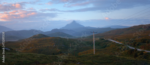 The western slope of Mount Ben Stack and the road through the valley at dawn. North West Sutherland, Scotland