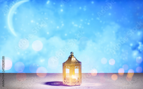 Lantern with candle on table against blurred background. Islamic New Year celebration photo