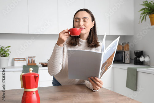Pretty young woman with cup...