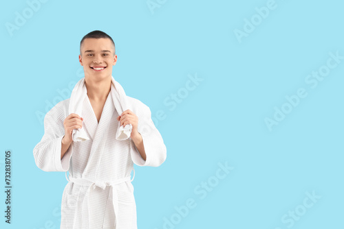 Teenage boy in bathrobe wit...