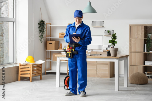 Male electrician with clipb...