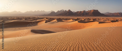 The Sahara Desert  with its sandy terrain and rugged panorama  offers a stunning sunset view 
