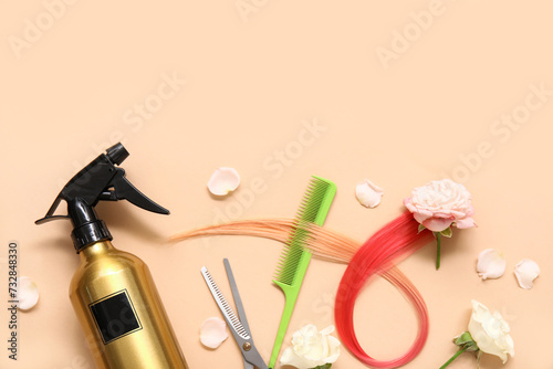 Hairdresser's tools with pink hair strand and beautiful roses on beige background