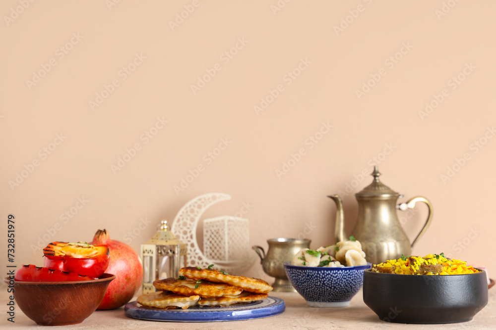 Traditional Eastern dishes and Muslim decor on beige background. Ramadan celebration Traditional Eastern dishes and Muslim decor on beige background. Ramadan celebration