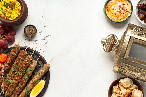 Traditional Eastern dishes and Muslim lamp on white table. Ramadan celebration