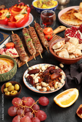 Different traditional Eastern dishes on black table. Ramadan celebration