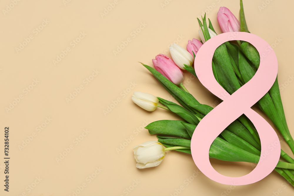 Figure 8 made of paper and beautiful tulips on brown background. International Women's Day