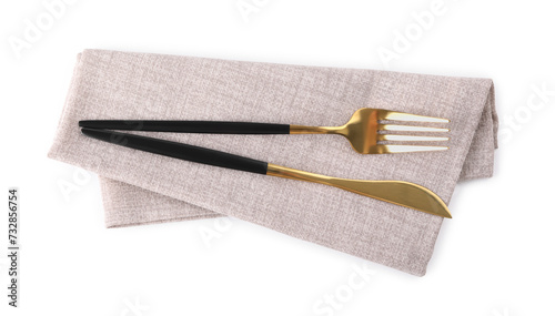 Grey napkin with golden fork and knife isolated on white, top view. Cutlery set