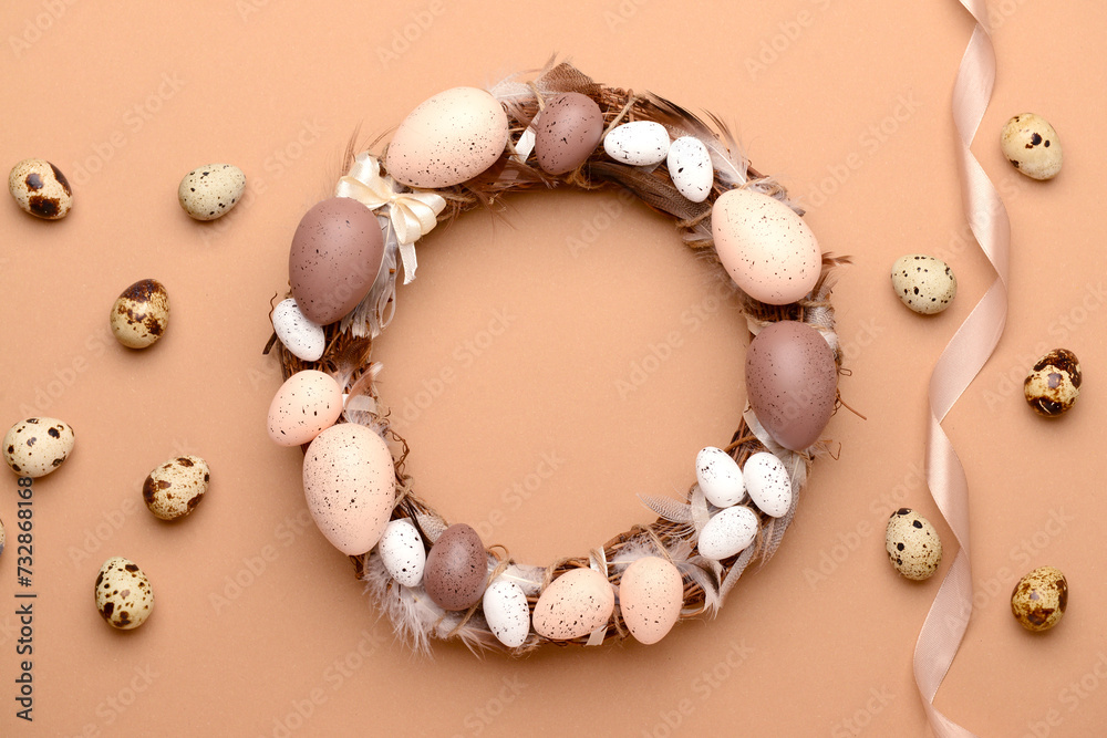 Easter wreath made of eggs and feathers on beige background Easter wreath made of eggs and feathers on beige background