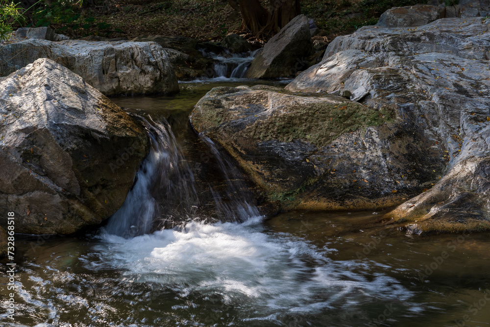 summer waterfall stream with rocks on nature clear flow motion water from trees in jungle or fresh natural forest at Phalad Waterfall in rainforest Lan sang national park for landscape background summer waterfall stream with rocks on nature clear flow motion water from trees in jungle or fresh natural forest at Phalad Waterfall in rainforest Lan sang national park for landscape background