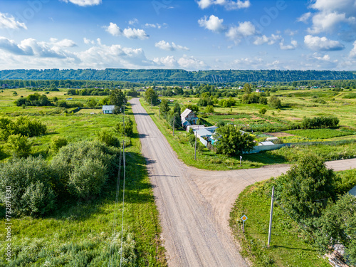 Crossroads of rural streets in a village with few houses, country roads form a T-junction