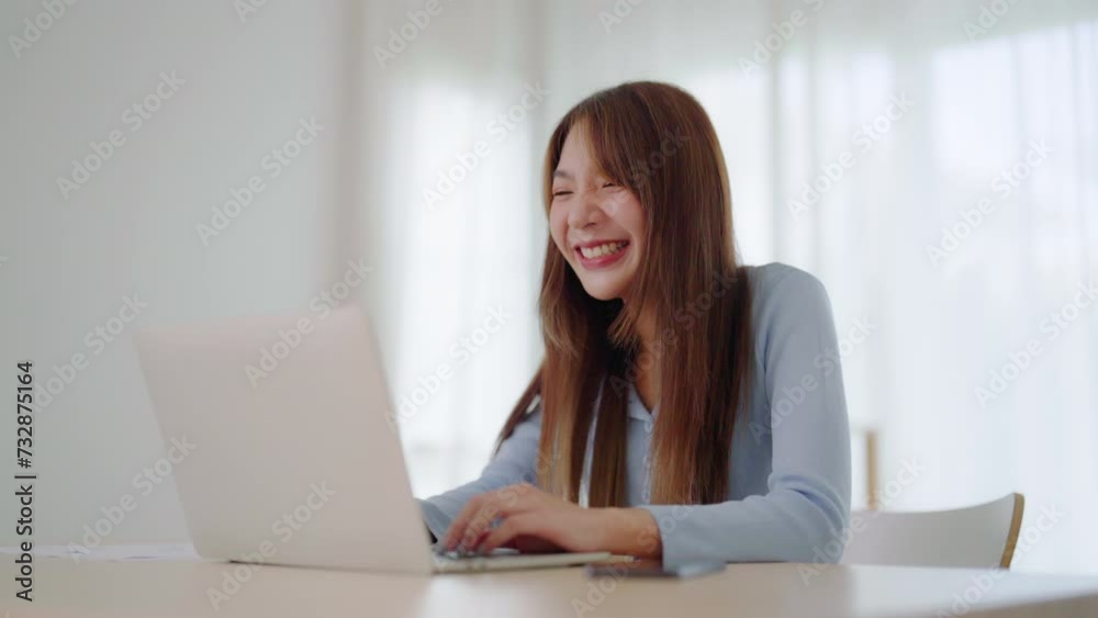 Young asian woman working on computer laptop at house. Work at home, Video conference, Video call, Student learning online class, meeting conference Young asian woman working on computer laptop at house. Work at home, Video conference, Video call, Student learning online class, meeting conference