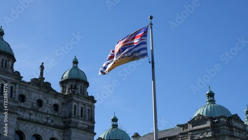 Flag of British Columbia waving in front of the Legislative Assembly of British Columbia Parliament Building in Victoria on Vancouver Island in Canada