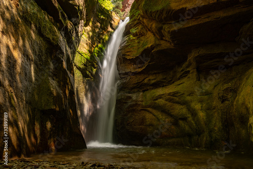 Waterfall at end of Bear Trap Canyon pours over cliff