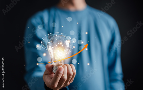 Hand man holding illuminated lightbulb, idea, innovation and inspiration with glowing virtual brain, smart intelligent creativity with bulbs, Motivation and innovation