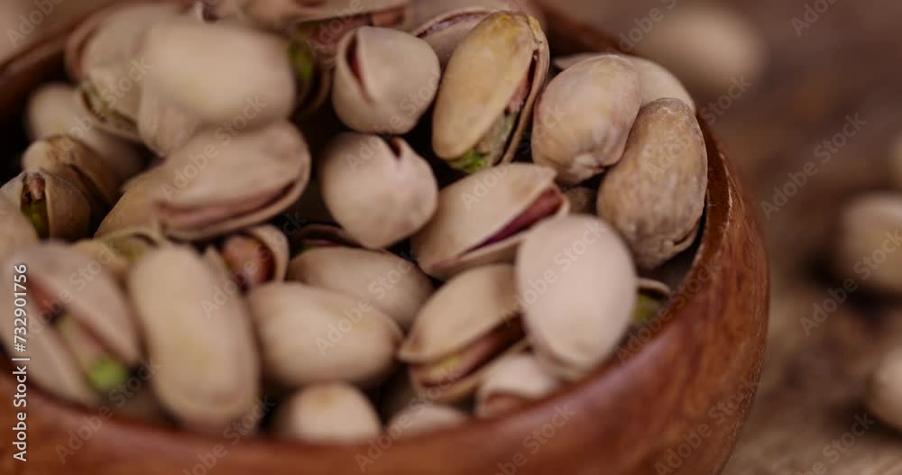 Salted fried pistachios on the table, pistachio nuts close-up Salted fried pistachios on the table, pistachio nuts close-up