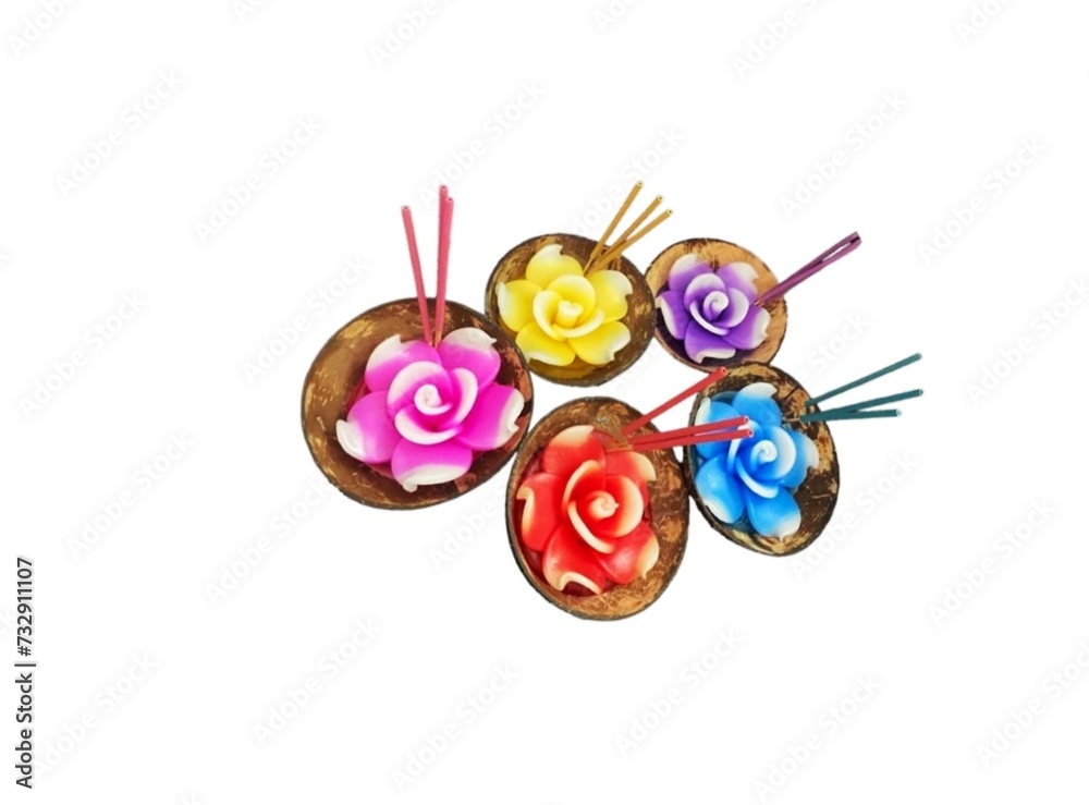 In the picture there is a small cup of brown coconut shell. In the cup there are candles in different colors in the shape of flowers with a white string in the middle to use as a light, very colorful In the picture there is a small cup of brown coconut shell. In the cup there are candles in different colors in the shape of flowers with a white string in the middle to use as a light, very colorful