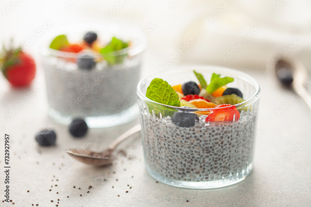 Chia puddind with fruit berry salad in bowl on grey background. Healthy breakfast Chia puddind with fruit berry salad in bowl on grey background. Healthy breakfast