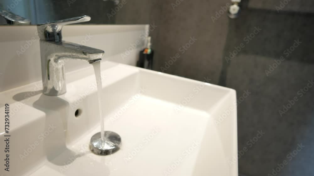 water pouring from a faucet tap slow motion water pouring from a faucet tap slow motion