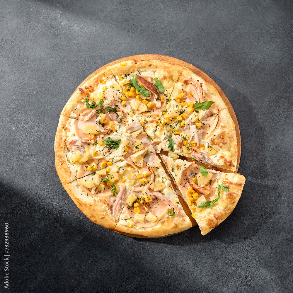 Hawaiian pizza with chicken, pineapple, and corn, a sweet and savory combination on a perfectly baked crust