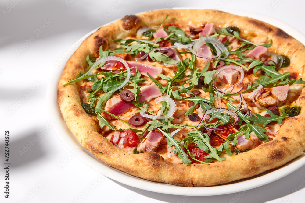 Artistic Niçoise-Style Tuna Pizza with Olives and Arugula on Shadowed White Artistic Niçoise-Style Tuna Pizza with Olives and Arugula on Shadowed White