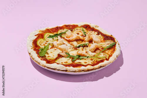 Gluten-free pizza with shrimp and zucchini on a pink background