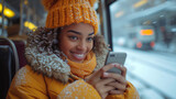 a happy african american teen woman riding the train in the winter while using her phone,generative ai