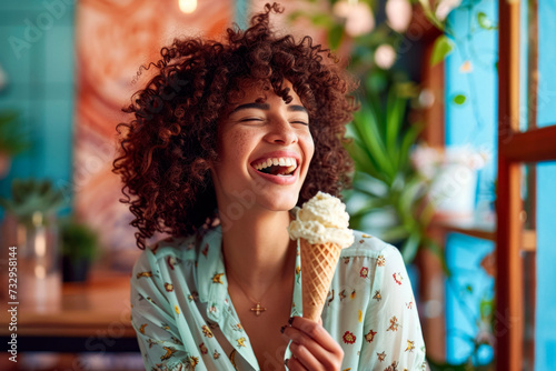 Free-spirited woman with afro, eating vegan ice-cream in eclectic interior design cafe, summer urban lifestyle photo