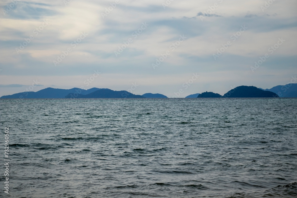 calm landscape of the sea and distant mountains
calm landscape of the sea and distant mountains