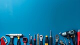 Various handy tools arranged on bright blue background with copy space, concept of DIY, home improvement, and repair