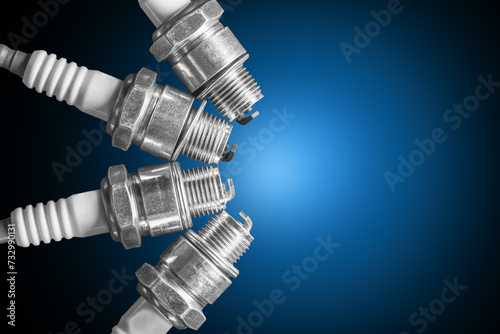 Spark plugs on blue gradient background photo