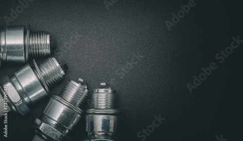 Spark plugs on gray gradient background photo