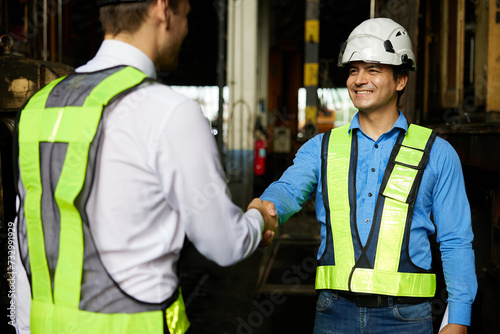 engineers or workers shaking hands before starting work at construction site