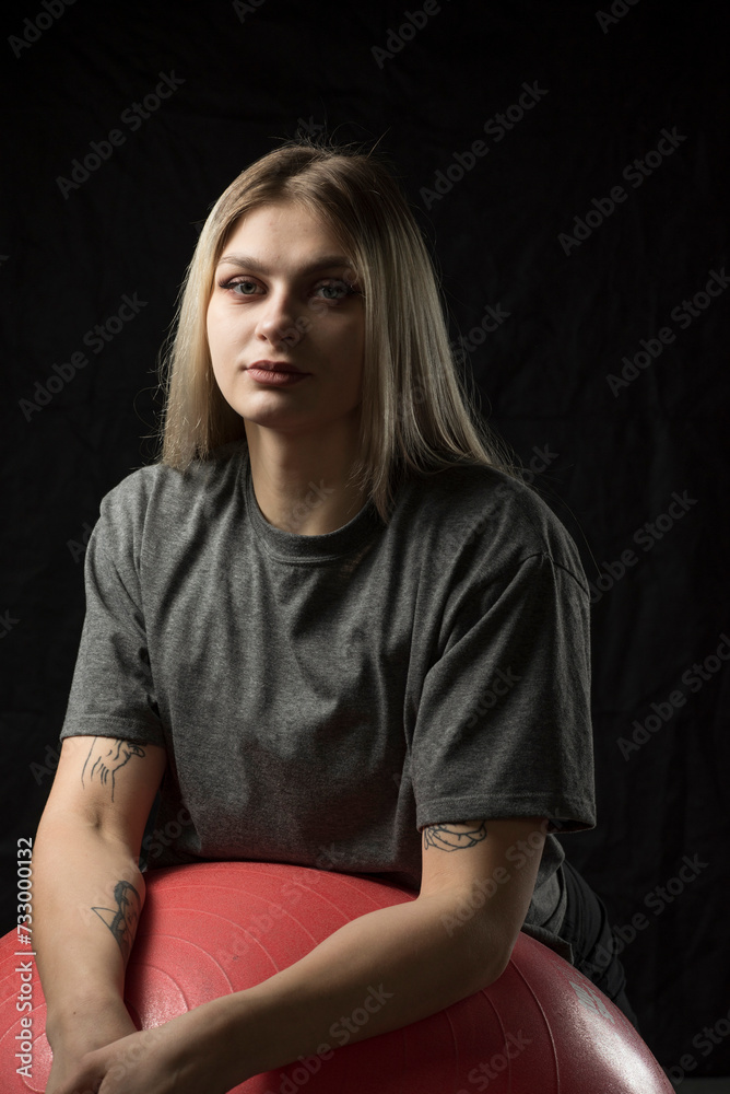 A beautiful young girl is working out in the gym in sportswear. A beautiful young girl is working out in the gym in sportswear.