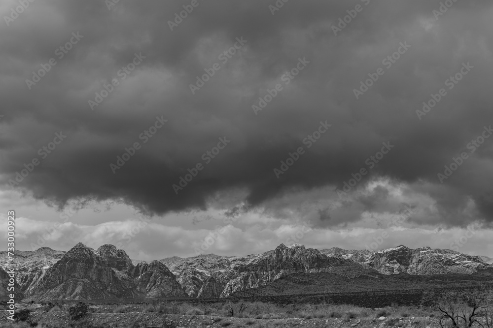 clouds over mountains in black and white